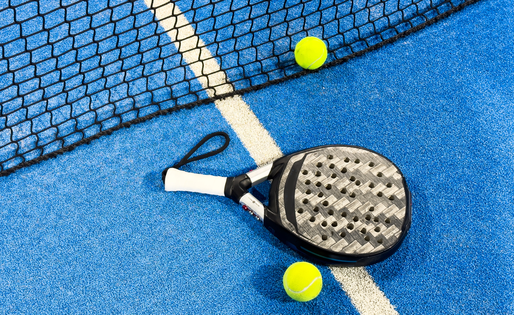 Paddle racket with a ball ready to play the fastest growing sport in recent years worldwide. Padel